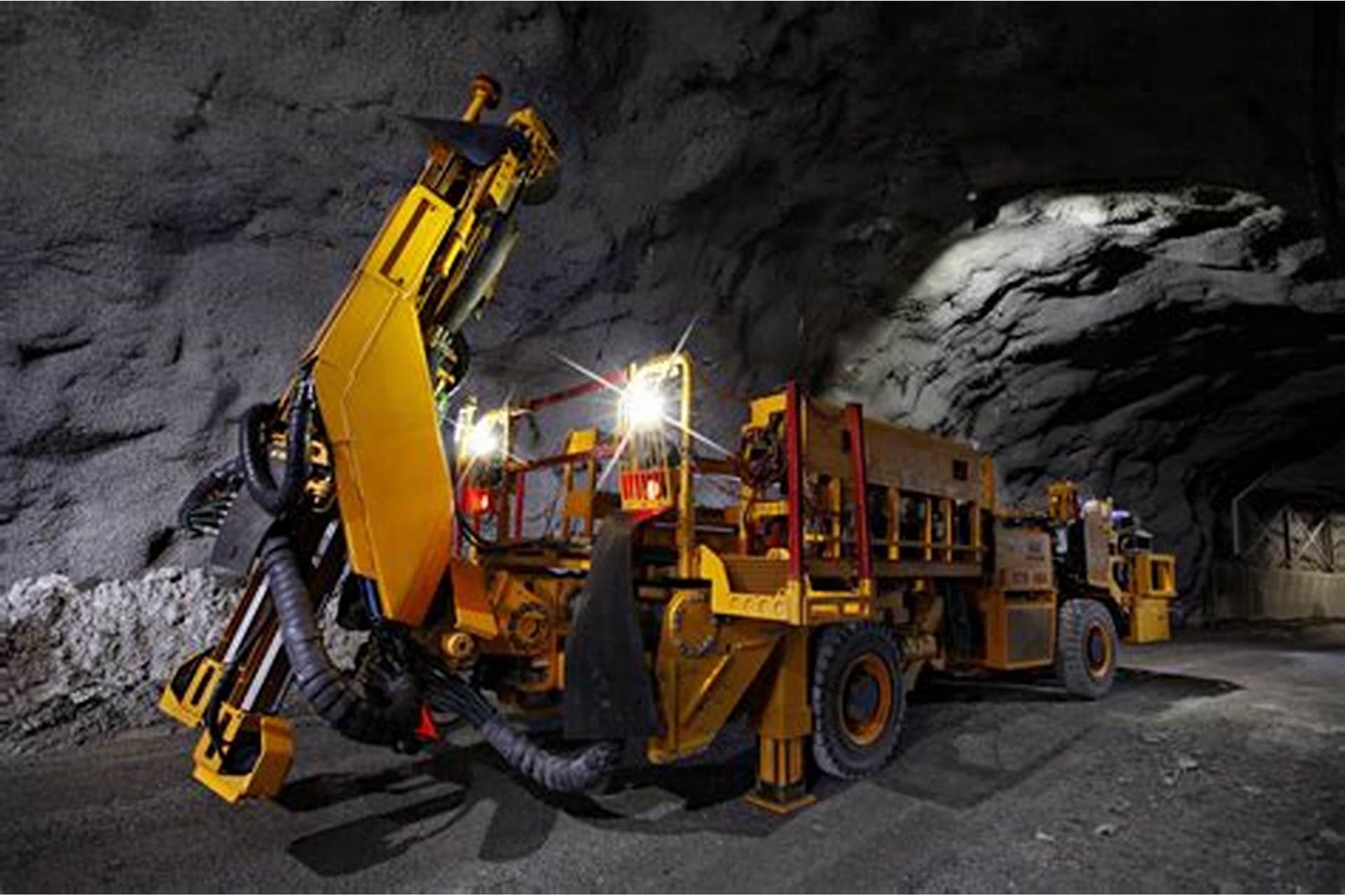 Underground mining drill jumbo operating in a rock tunnel